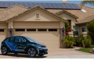 Electric Vehicle In Front Of A Home With Solar